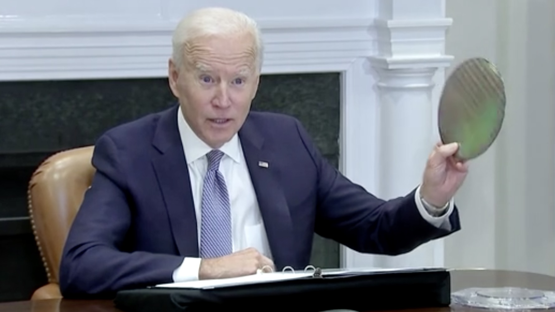 U.S. President Joe Biden holds a wafer as he speaks at White House Summit in Washington, U.S., April 12, 2021. /Reuters