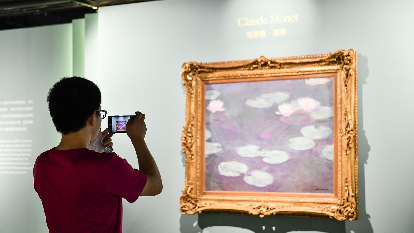 A visitor looks at a painting by Claude Monet /Meet You Museum