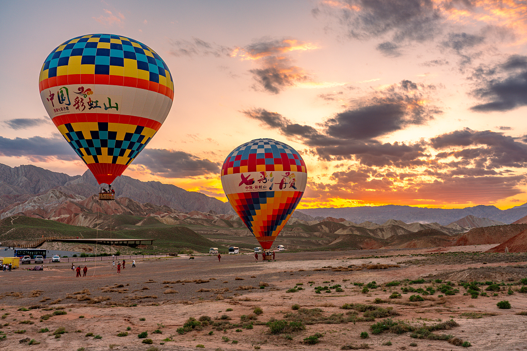 Hot air balloons of various colors blend with a Danxia landscape in Zhangye City, Gansu Province. /CFP