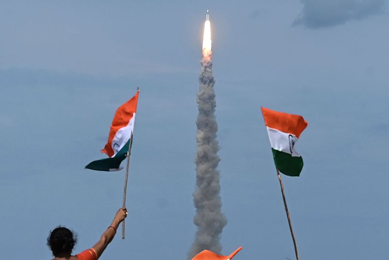 People wave Indian flags as an Indian Space Research Organization (ISRO) rocket carrying the Chandrayaan-3 spacecraft lifts off from the Satish Dhawan Space Centre in Sriharikota, an island off the coast of southern Andhra Pradesh state, July 14, 2023. /CFP