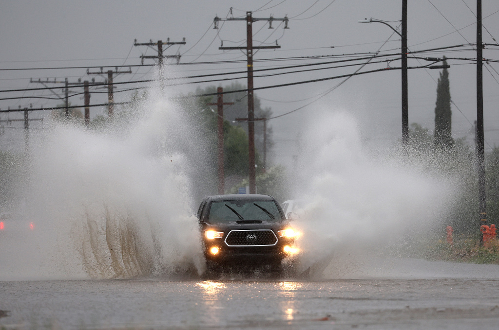 A car drives on a flooded street as tropical storm Hilary approaches in Redlands, California, U.S., August 20, 2023. /CFP 
