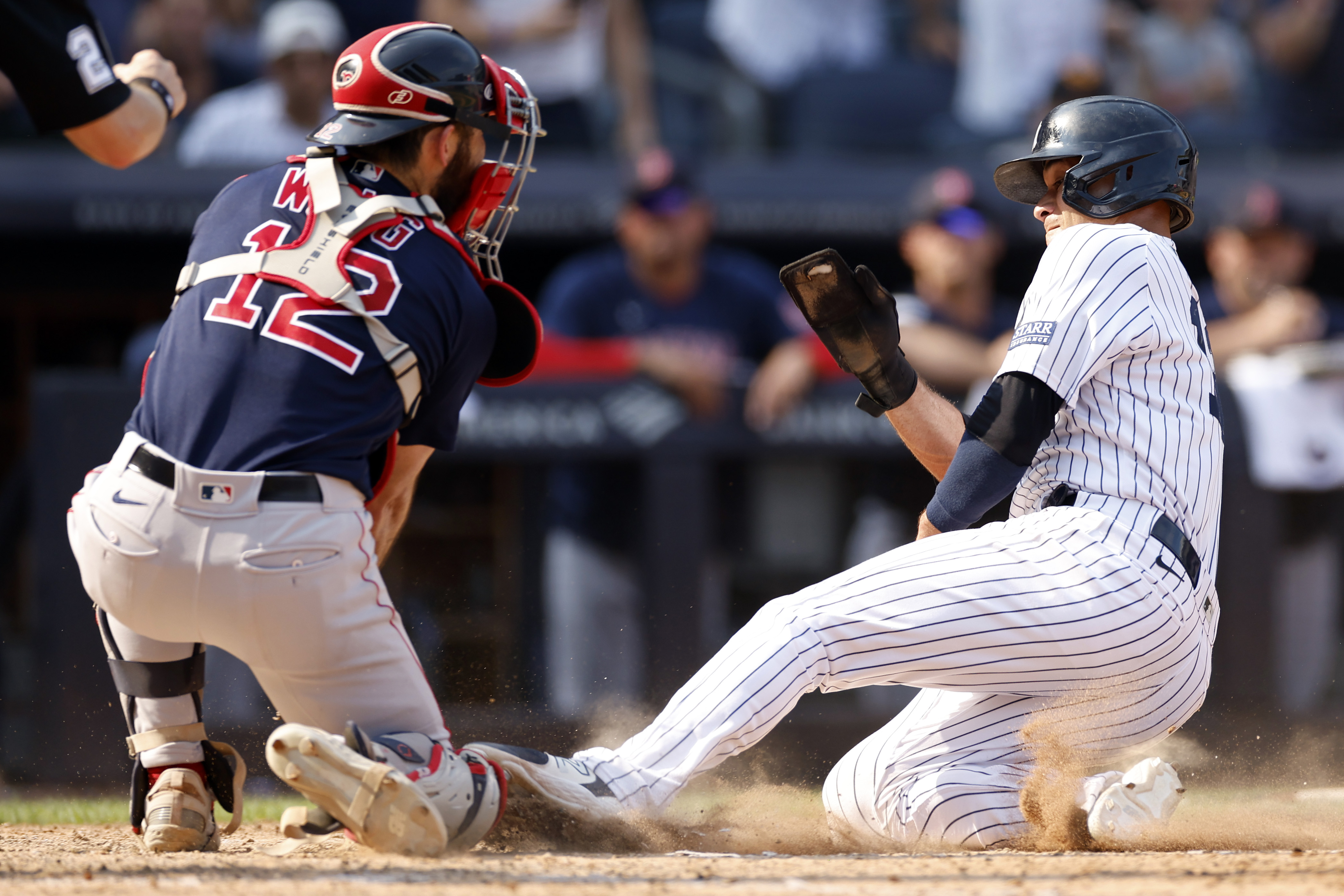 Isiah Kiner-Falefa (R) of the New York Yankees slides into the home plate during the eighth inning of the game against the Boston Red Sox at Yankee Stadium in New York City, August 20, 2023. /CFP