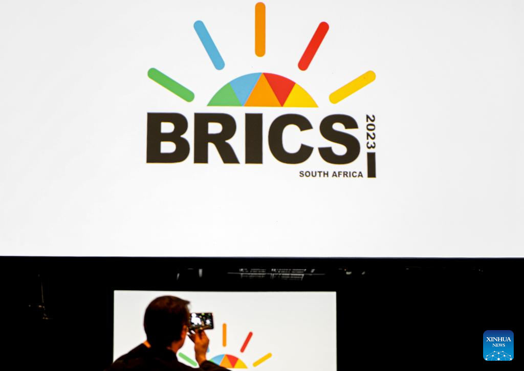 A man takes photos at the media center of the 15th BRICS Summit in Johannesburg, South Africa, Aug. 21, 2023. /Xinhua