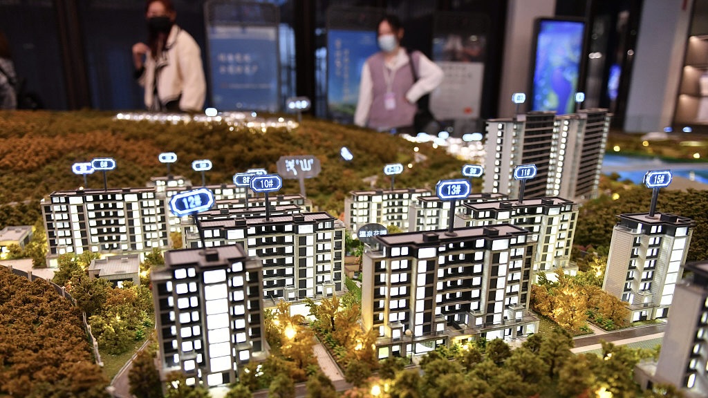 Visitors look at a model of a residential development in Zhangzhou, Fujian Province, March 27, 2023. /CFP