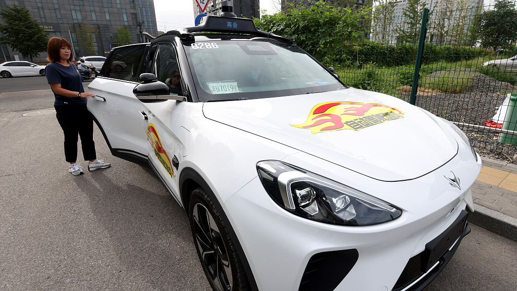 Passenger experiences a driverless car at the 2023 World Robot Conference in Beijing, China, August 18, 2023. /CFP