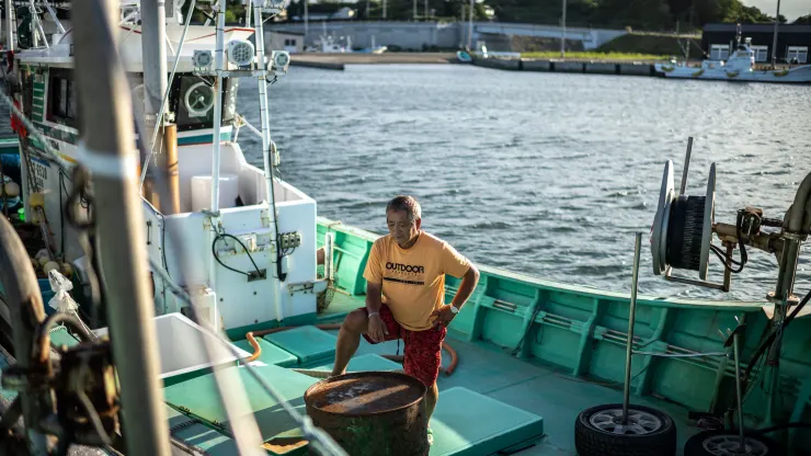 Fisherman Haruo Ono stands on one of his fishing boats at Tsurushihama Fishing Port, Shinchi-machi of Fukushima Prefecture, some 60 kms north of the crippled Fukushima Daiichi nuclear plant on August 21, 2023, ahead of a government's plan to begin releasing treated water from the plant into the Pacific Ocean. /AFP