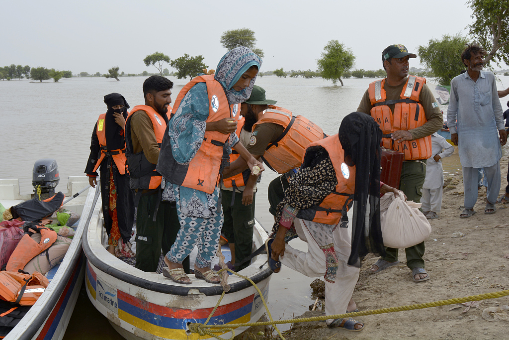 Rescue workers evacuate villagers on a boat from a flooded area of Pakpattan district of Pakistan's Punjab province, August 23, 2023. /CFP