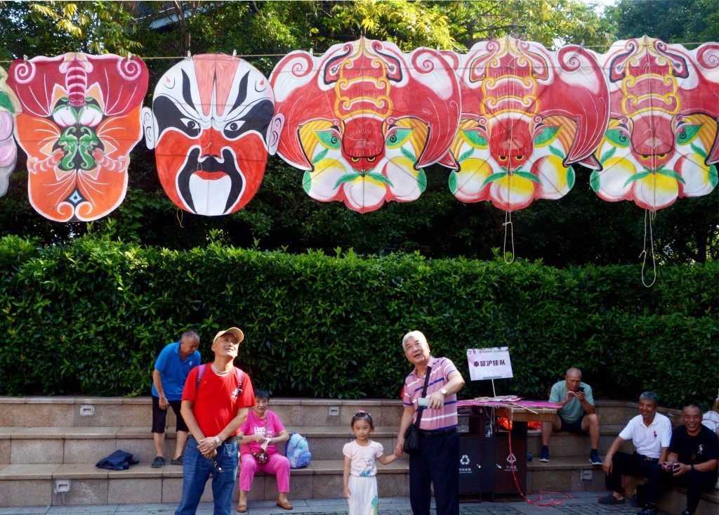 Kites of different shapes and designs are hung up for exhibition during a kite show held on August 24, 2023 at The Bund in Shanghai. /CFP