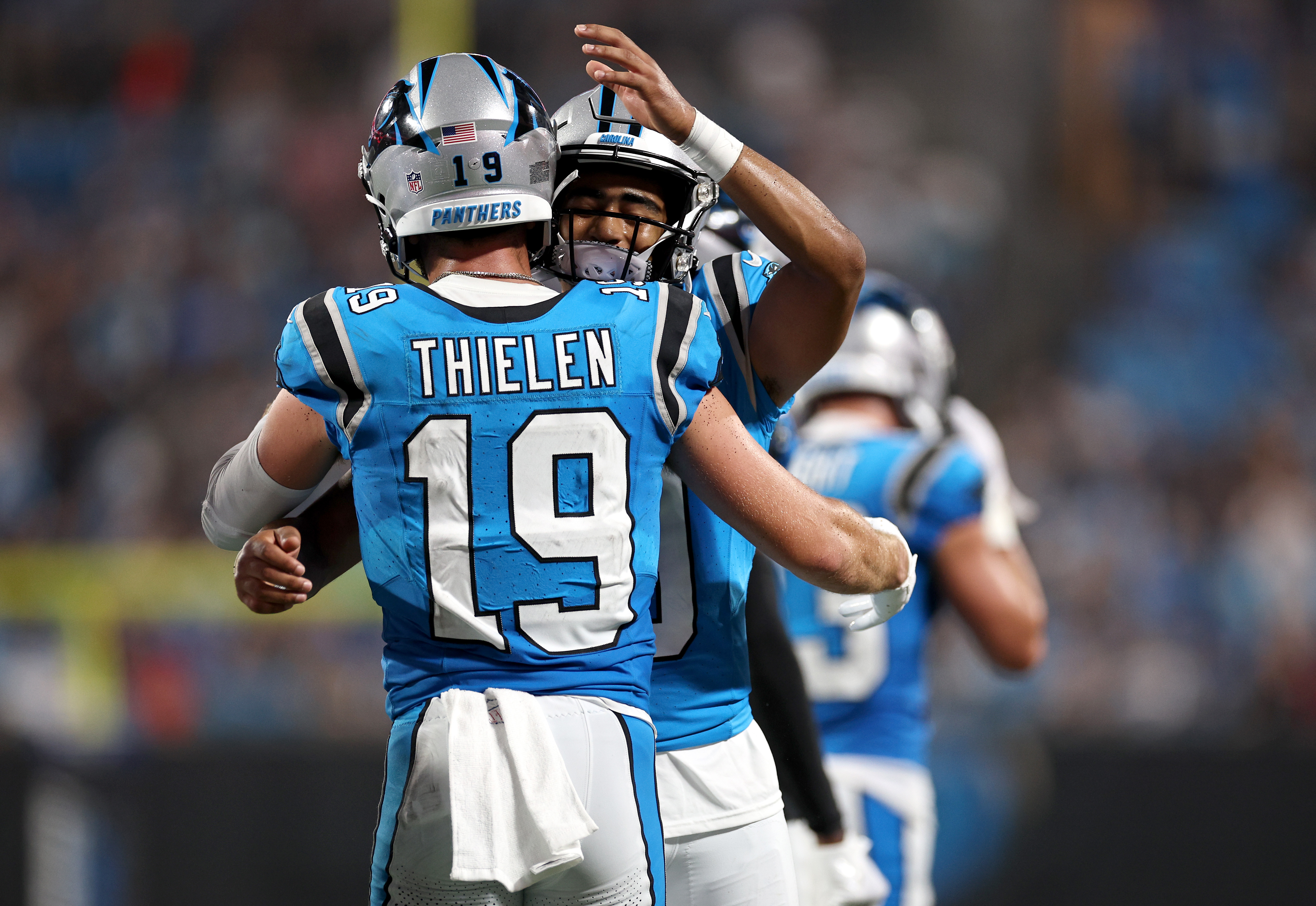 Wide receiver Adam Thielen (#19) and quarterback Bryce Young of the Carolina Panthers hug each other to celebrate after scoring a touchdown in the pre-season game against the Detroit Lions at Bank of America Stadium in Charlotte, North Carolina, August 25, 2023. /CFP 