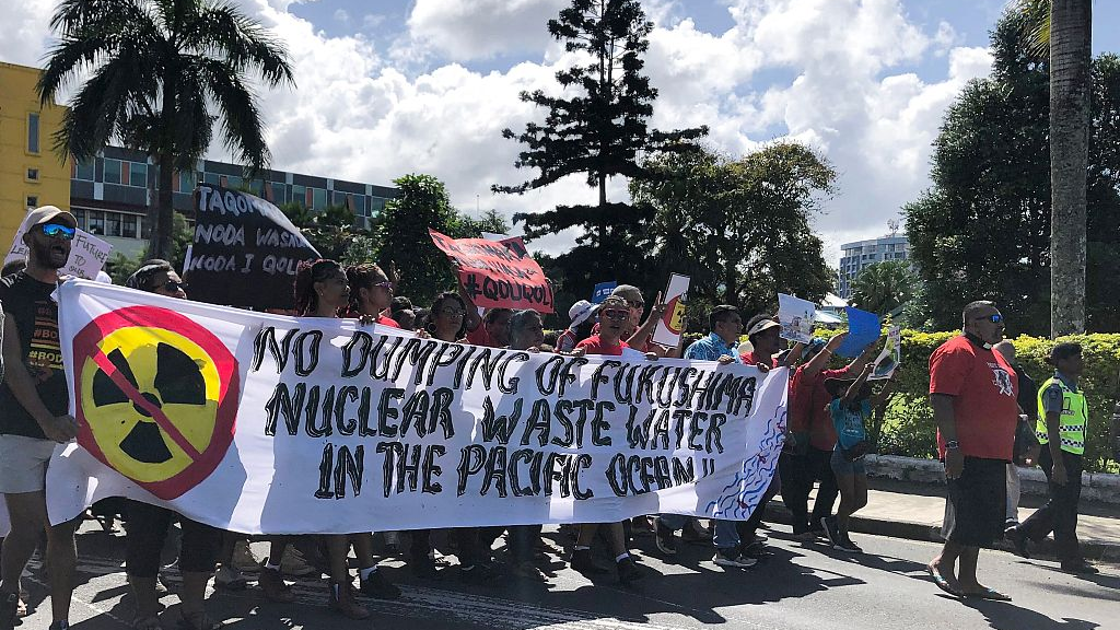 Protesters holding a banner and placards march on the streets of Fiji's capital city Suva against Japan's release of nuclear-contaminated wastewater into the Pacific Ocean, August 25, 2023. /CFP