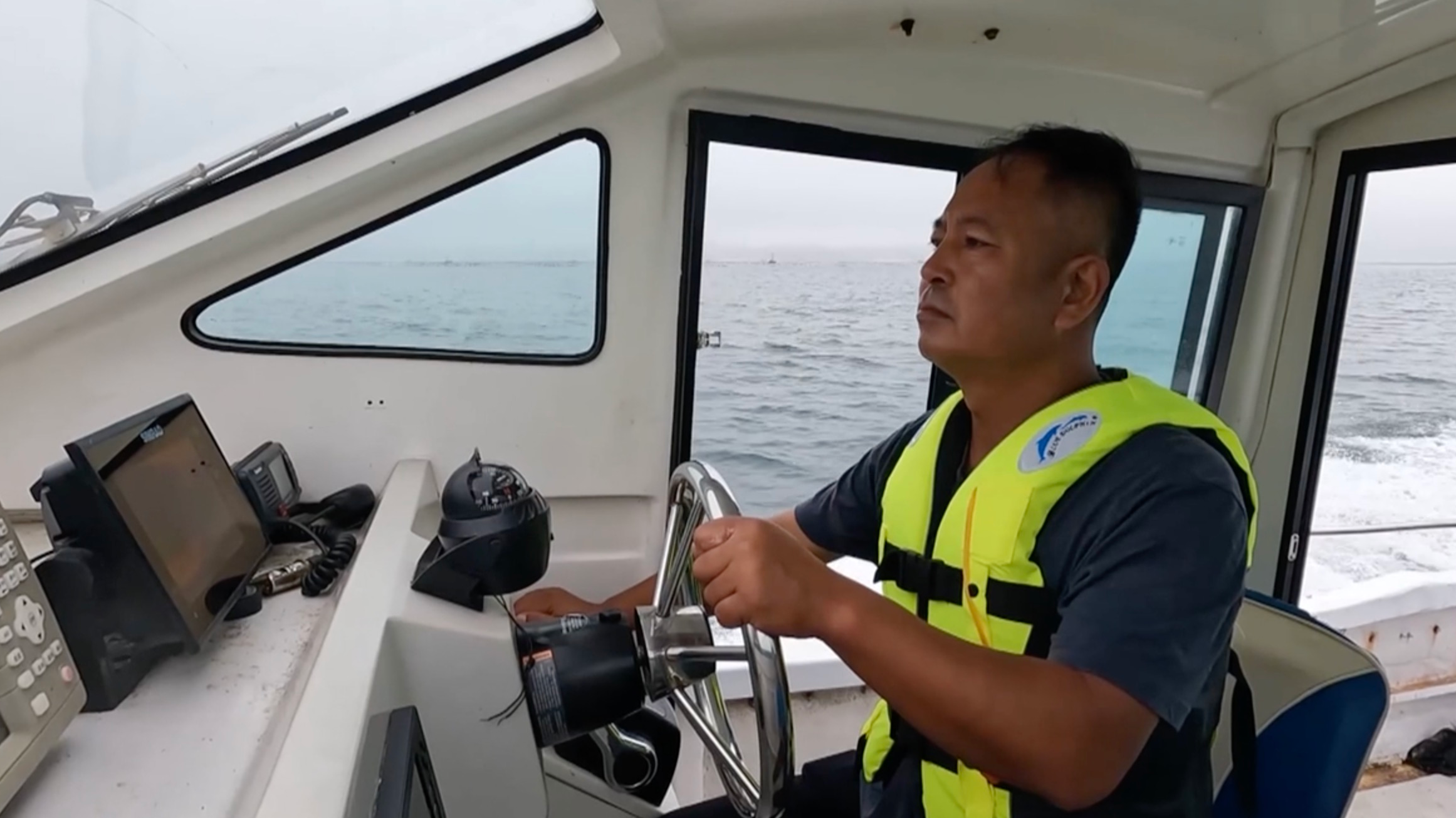 Liang Zeye patrols the sea to safeguard the finless porpoises. /CMG