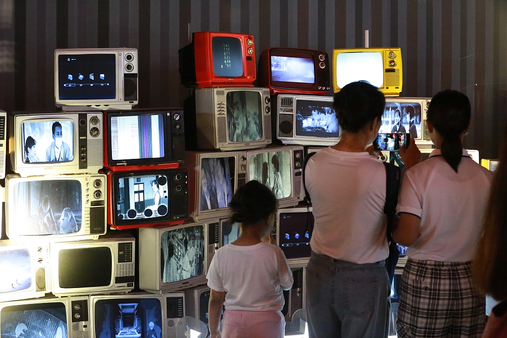 A photo taken on July 25, 2023, shows visitors taking photos with filmed-theme installations at the Changchun Film Carnival in Changchun, Jilin Province, China. /CFP