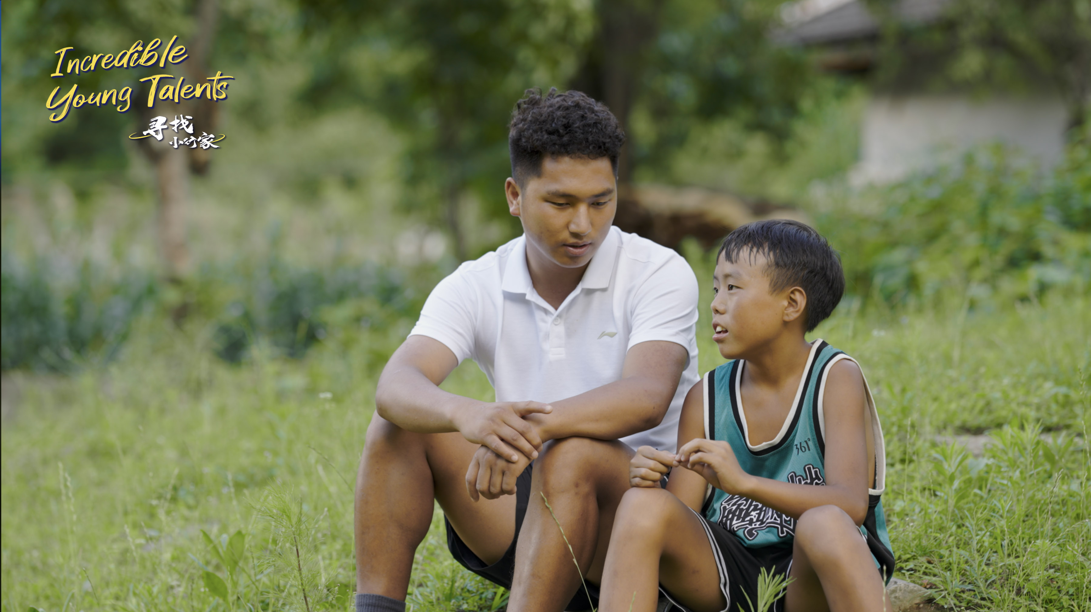 13-year-old boy Guguluojiazi sits next to his coach, Waeramu. This photo was taken in August 2023 by a CGTN film crew as they shot an episode of the series 