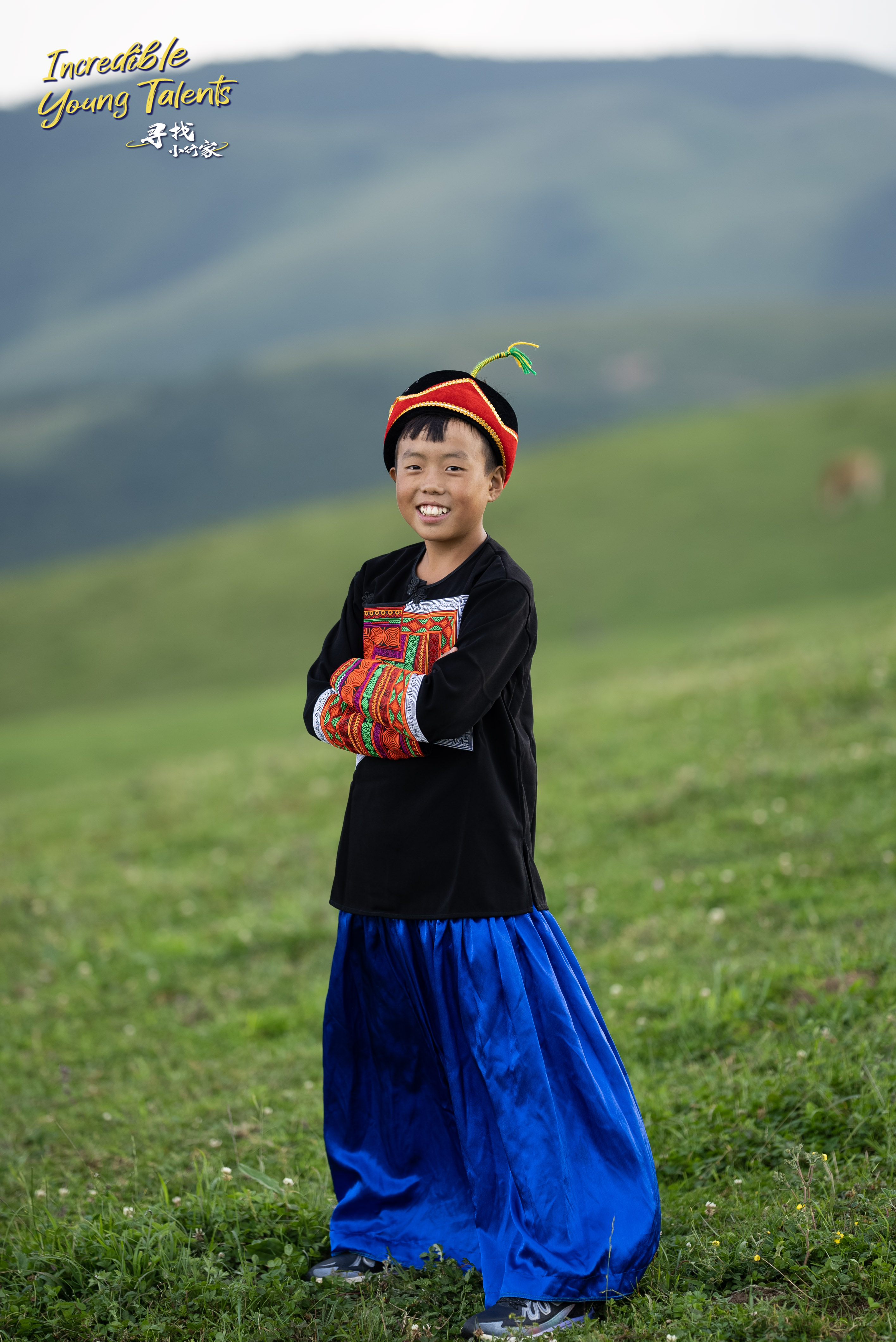 13-year-old boy Guguluojiazi poses for a photo in Yi ethnic clothing. This photo was taken in August 2023 by a CGTN film crew as they shot an episode of the series 