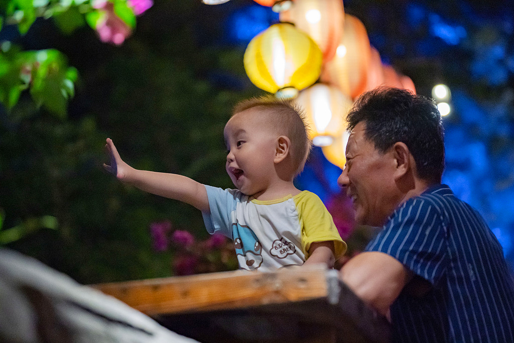 Visitors enjoy the night views from Shancheng Alley in Chongqing on August 30, 2023. /CFP