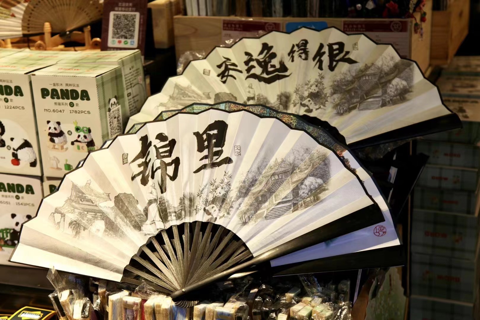 Fans featuring Chinese calligraphy and paintings are displayed at a souvenir shop in Jinli Ancient Street in Chengdu, Sichuan Province. /CGTN