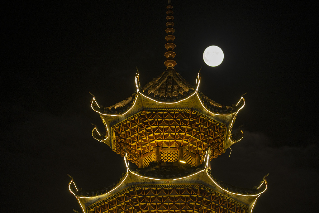 The blue supermoon is seen over a drum tower in Congjiang County, Guizhou Province on August 30, 2023. /CFP