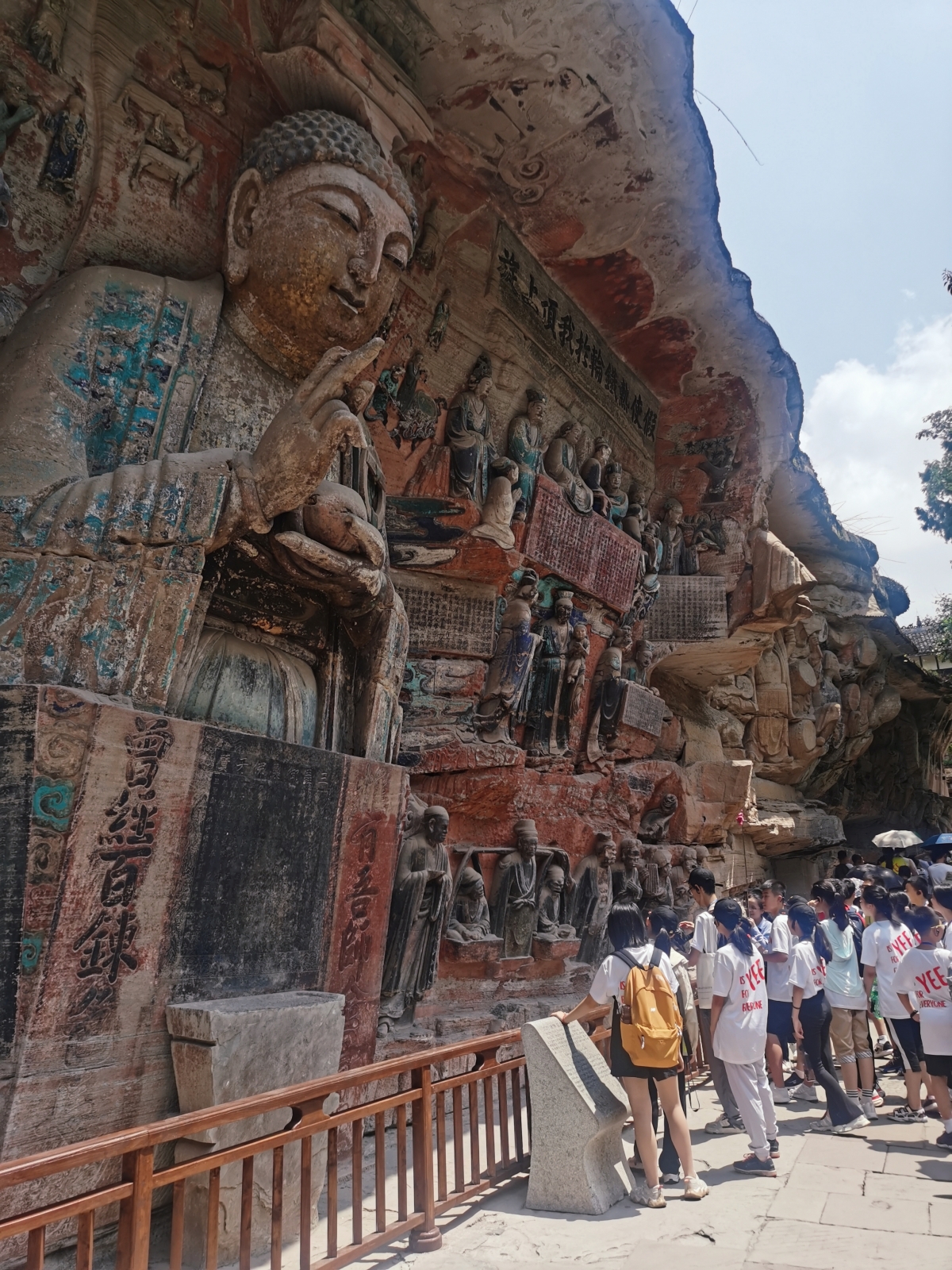 Tourists visit the Dazu Rock Carvings scenic spot in southwest China's Chongqing, August 22, 2023. /CGTN