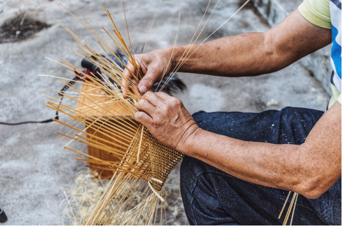 A photo shows a craftsman making a Dongpo bamboo hat. /Photo provided to CGTN