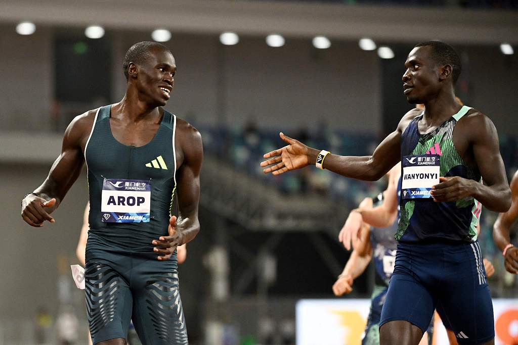 Golden medalist Emmanuel Wanyonyi of Kenya reaches out to silver medalist Marco Arop of Canada after the men's 800-meter event in the Diamond League in Xiamen, southeast China's Fujian Province, September 2, 2023. /CFP