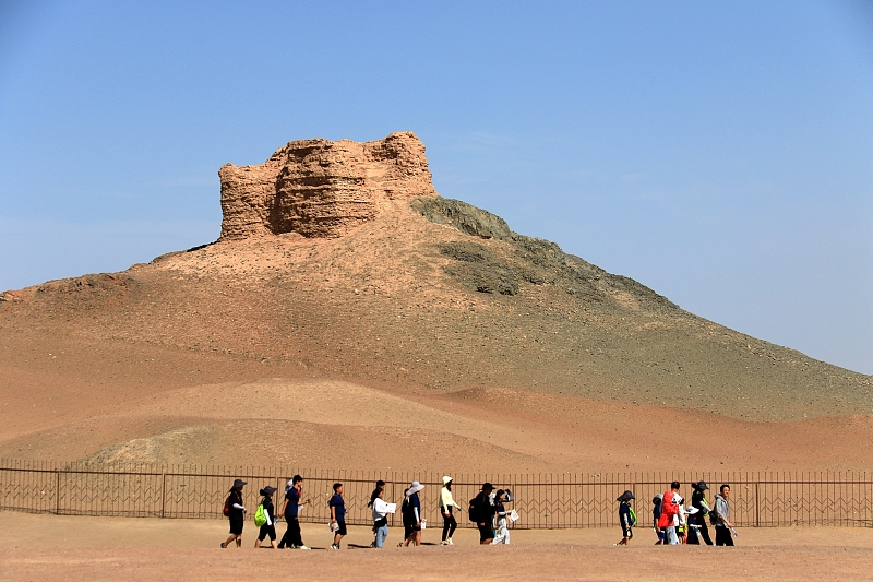 The file photo shows tourists visiting Yangguan Pass scenic spot in Dunhuang City, Gansu Province. /CFP