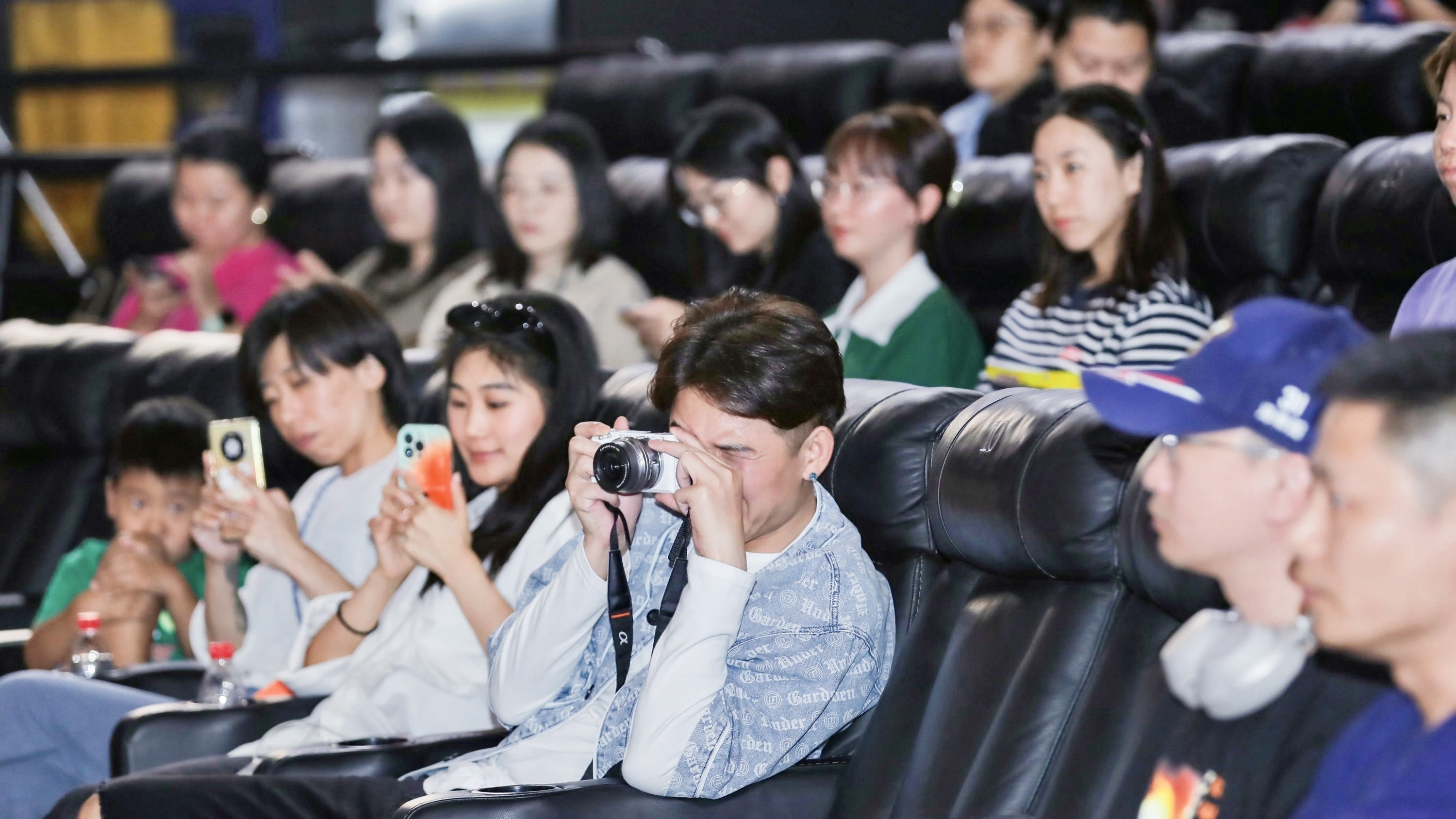 Fans are taking photos of the panel discussion after a screening of 'Oppenheimer' in Beijing on August 31, 2023. /Wanda Film