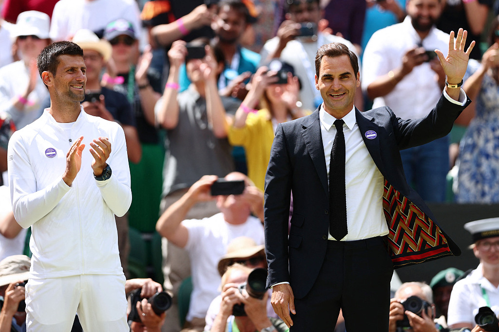 Roger Federer (R) waves next to Novak Djokovic as they take part in the Centre Court Centenary Ceremony on the seventh day of the Wimbledon Championships at the All England Tennis Club in Wimbledon, England, July 3, 2022. /CFP