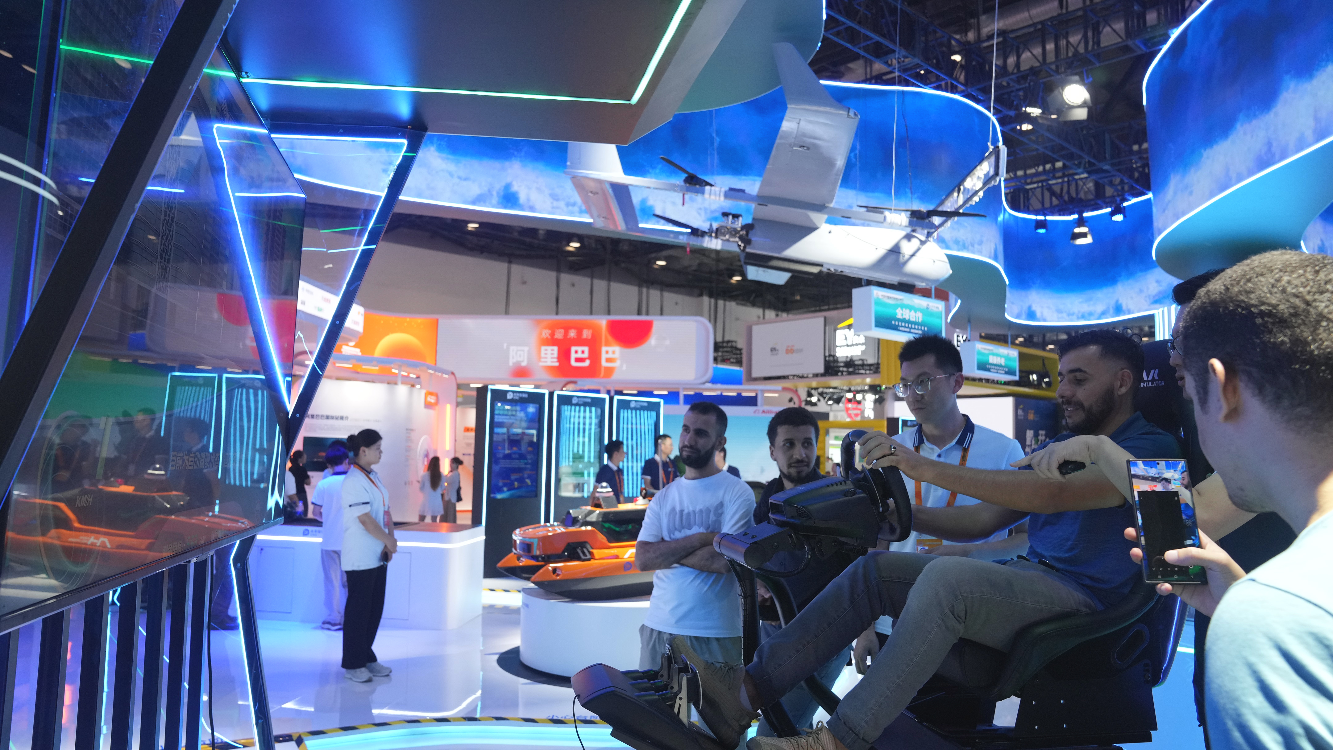 Visitors try driving at a booth.
