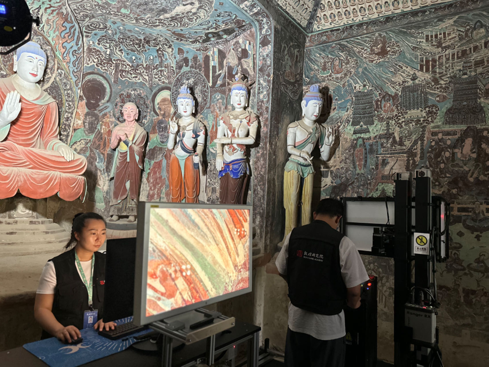 Staff from the Dunhuang Academy work on digitizing images taken in a cave at the Mogao Grottoes in Dunhuang, Gansu Province, on September 5, 2023. /CGTN