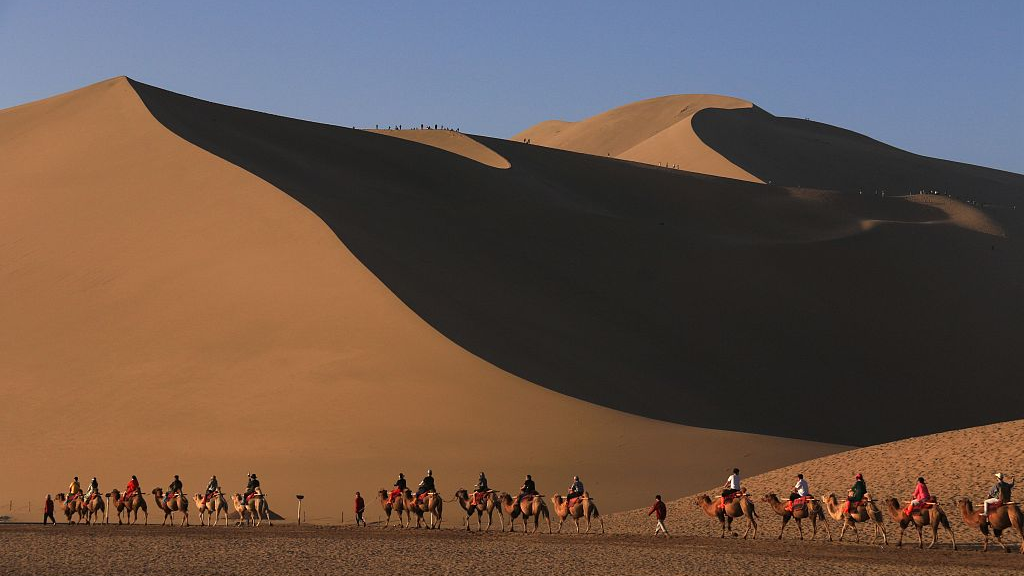 Tourists visit the Crescent Spring scenic area in Dunhuang City, Gansu Province, Sept. 3, 2023. / CFP