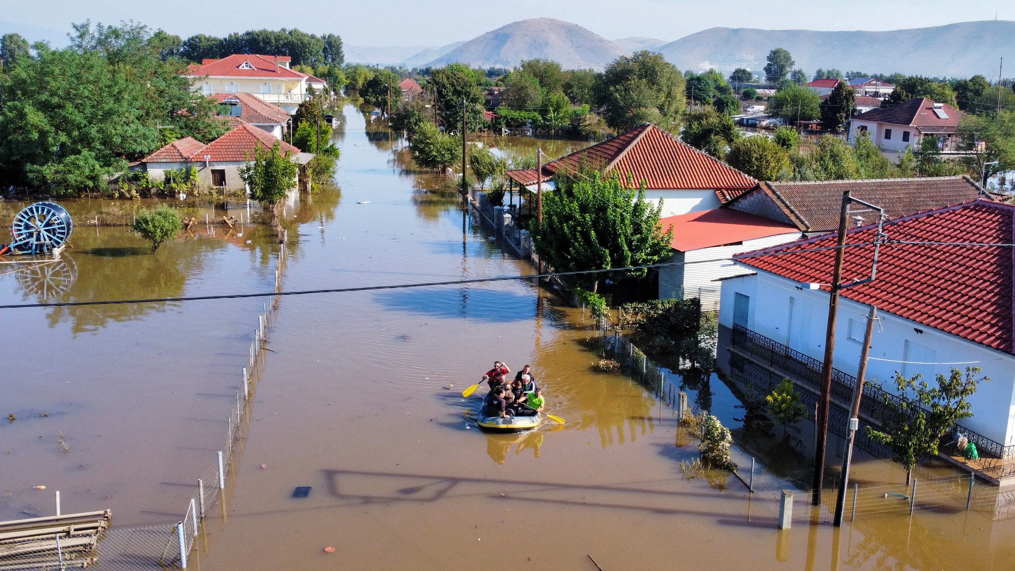 Locals get evacuated on a rubber boat as flood waters cover the town of Palamas, in the aftermath of Storm Daniel, Greece, September 8, 2023. /Reuters