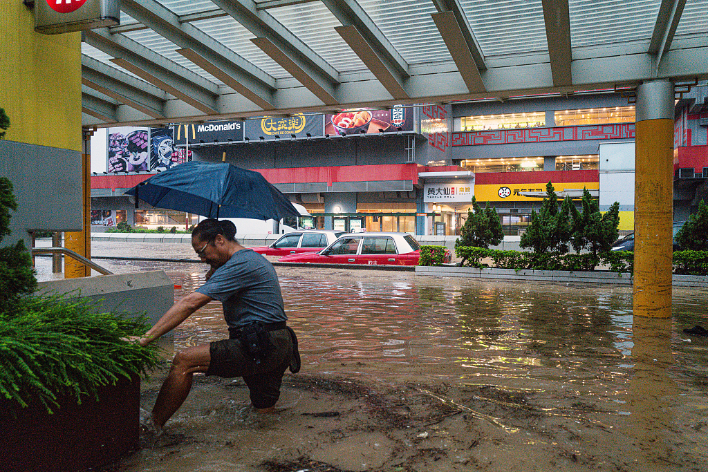 A resident wades through floodwaters during heavy rain in Hong Kong SAR, China, September 8, 2023. /CFP