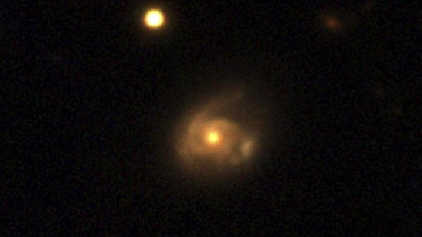 The interaction between a supermassive black hole in a galaxy named 2MASX J02301709+2836050 and a star orbiting it is seen in this image captured by the Pan-STARRS telescope, in Hawaii, U.S. /NASA