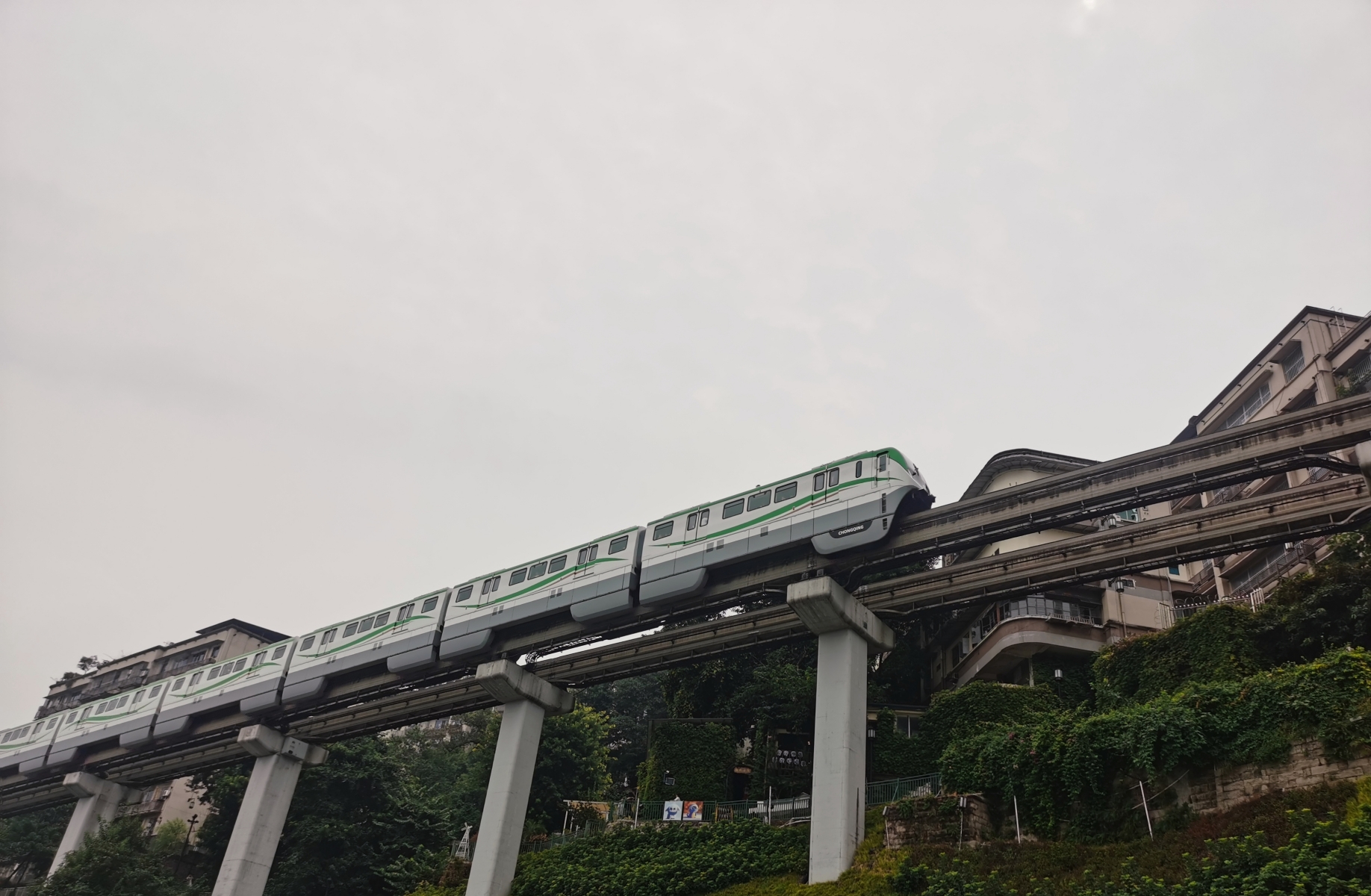 A passenger train runs near Liziba Monorail Station in southwest China's Chongqing, on August 24, 2023. /CGTN