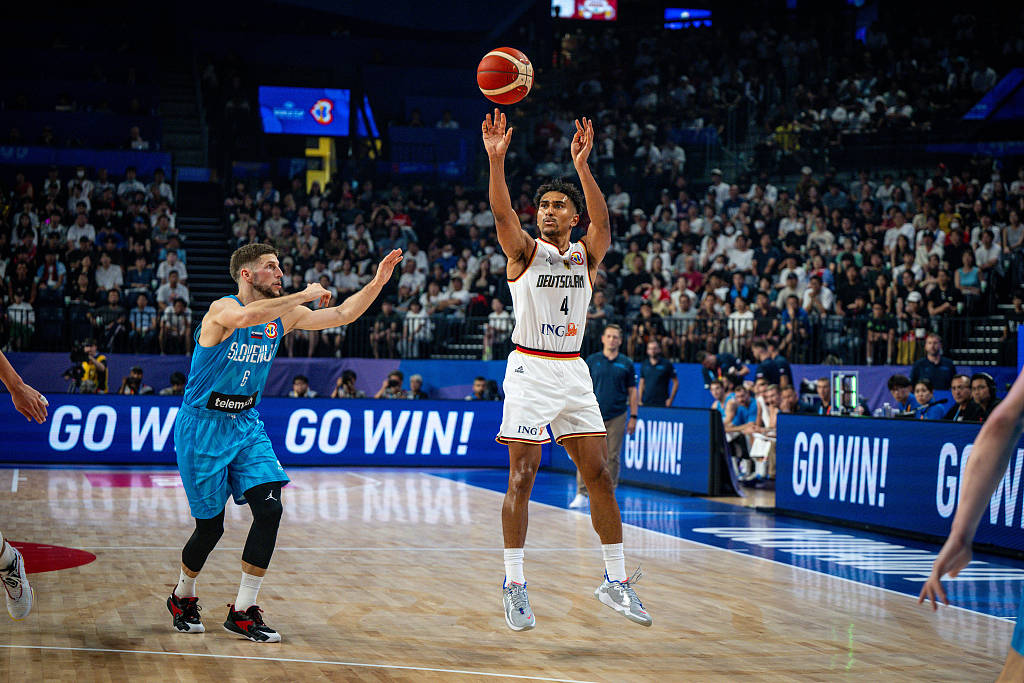 Mado Lo (R) of Germany shoots in the FIBA Basketball World Cup Round of 16 game against Slovenia at Okinawa Arena in Okinawa, Japan, September 3, 2023. /CFP