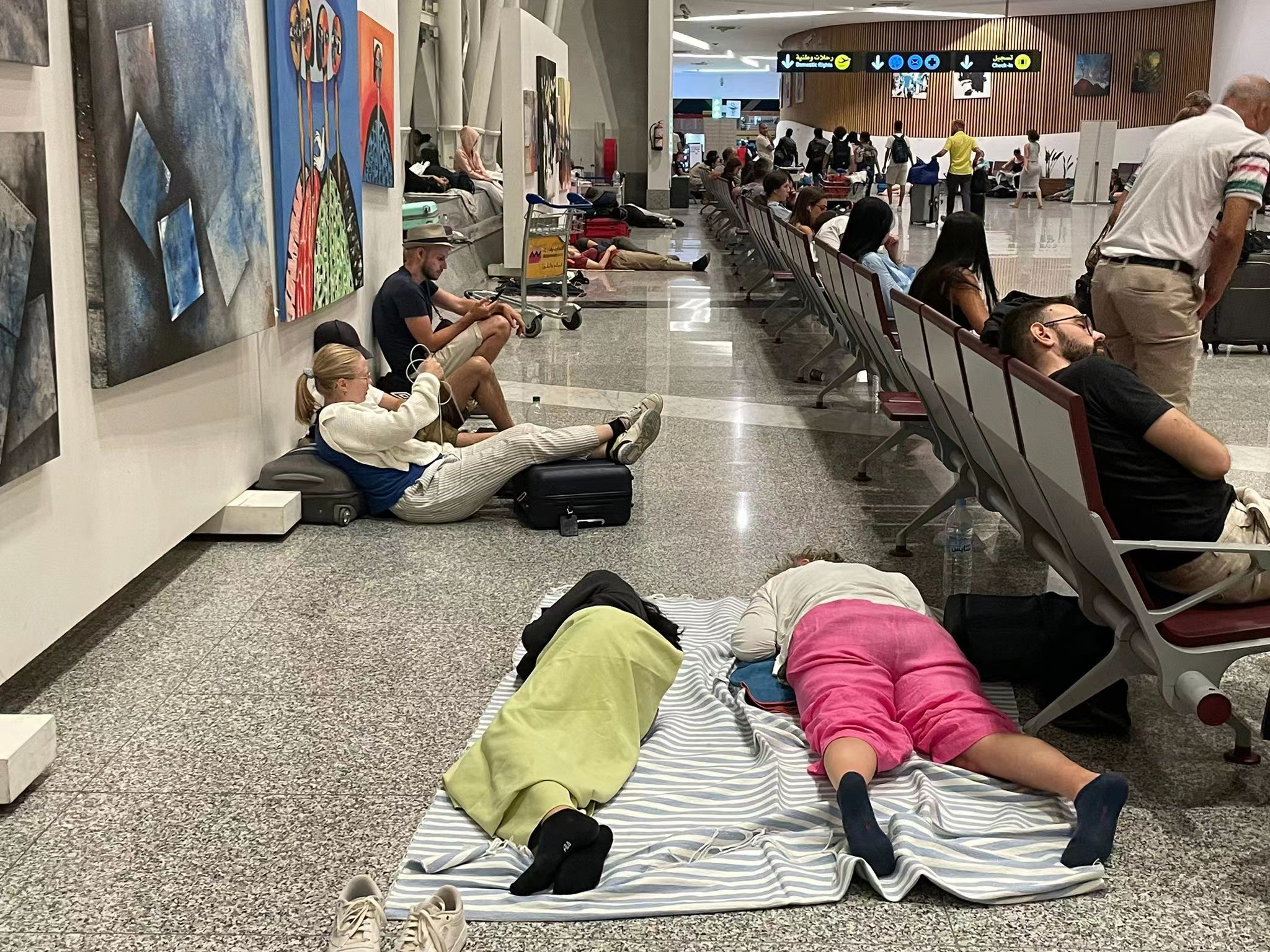 People sleep in Menara Airport after a magnitude-6.8 earthquake hit Morocco, September 9, 2023. Ken Browne/CGTN