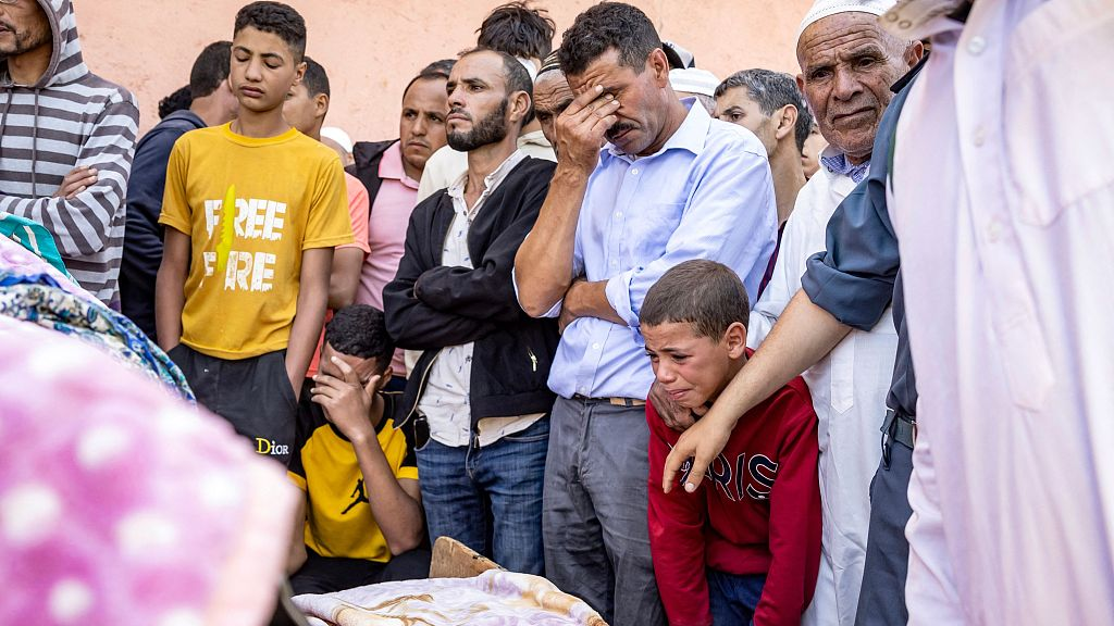 People mourn in front of the body of a victim killed in an earthquake in Moulay Brahim, Al Haouz province, September 9, 2023. /CFP
