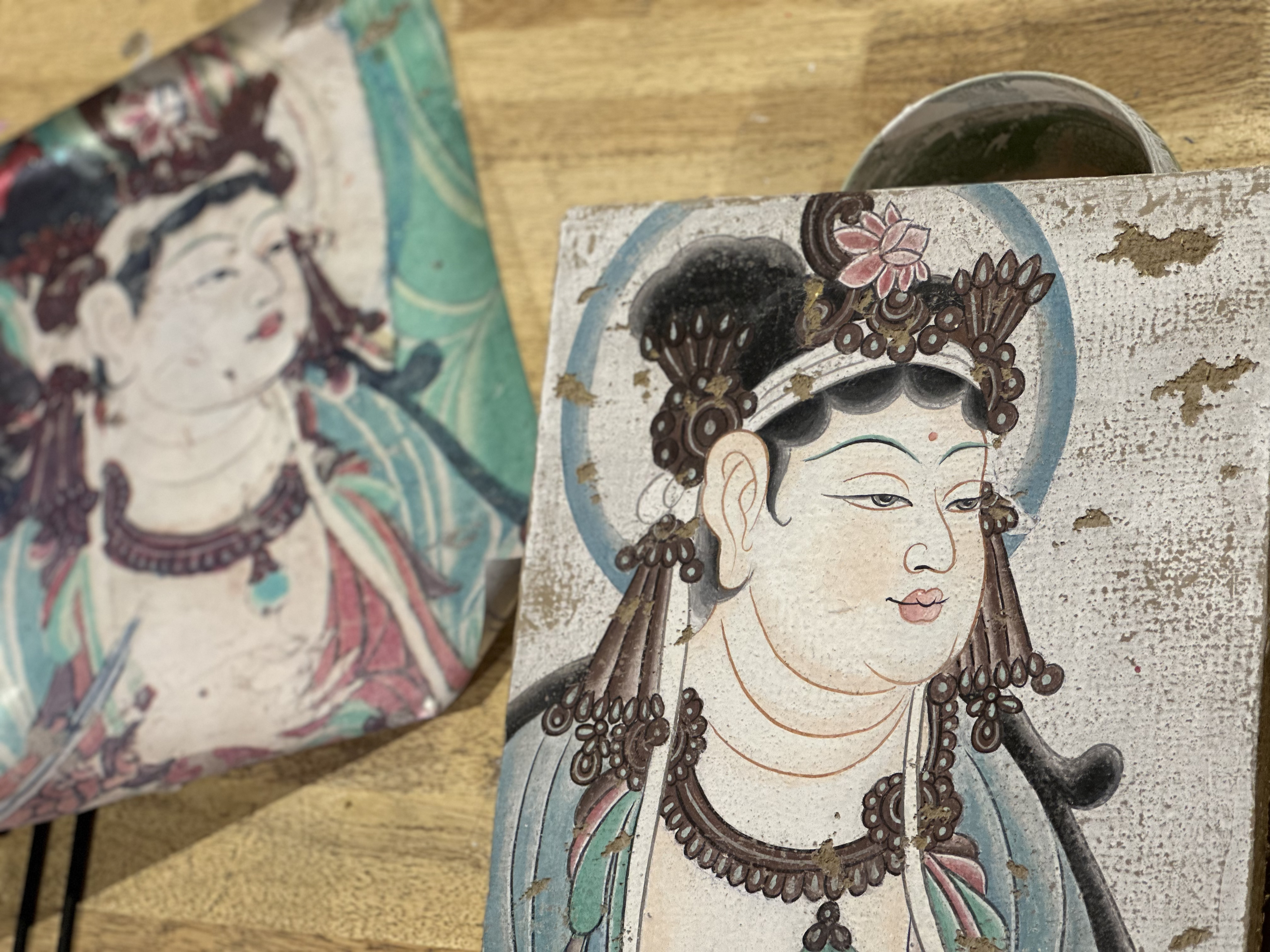 A hand-painted copy of a Dunhuang mural is photographed on a clay-made drawing board at the Dunhuang Art Academy in Dunhuang, northwest China's Gansu Province, on September 9, 2023. /CGTN