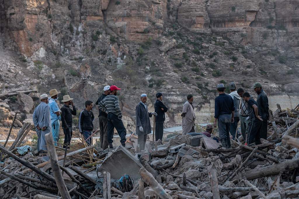 People gather around the rubble of homes in the mountain village of Imi N'Tala, south of Marrakesh, September 10, 2023. /CFP