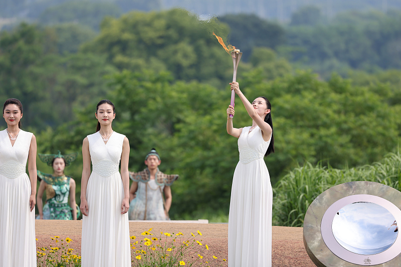 The 19th Asian Games flame is lit at the Liangzhu Ancient City Ruins Park in Hangzhou City, Zhejiang Province, June 15, 2023. /CFP