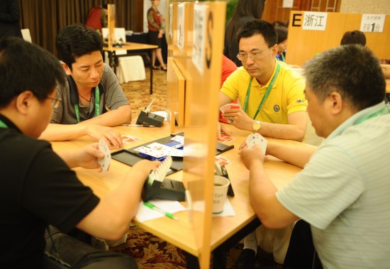 Dai Jianming (2nd R) plays bridge during the 4th China National Games in Hefei, central China's Anhui Province, May 21, 2010. /Xinhua