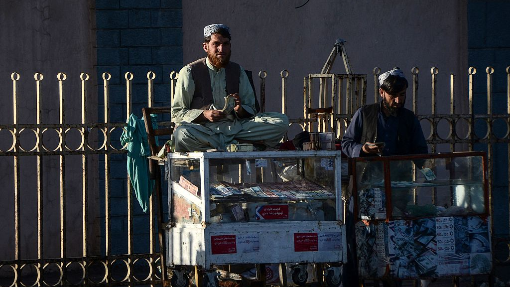 Money changers wait for customers along a road early in the morning in Kandahar, Afghanistan, January 19, 2022. /CFP