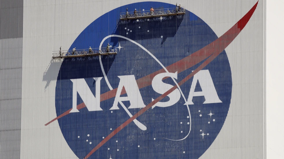 Workers pressure wash the logo of NASA on the Vehicle Assembly Building before SpaceX sending two NASA astronauts to the International Space Station at the Kennedy Space Center in Cape Canaveral, Florida, U.S., May 19, 2020. /Reuters