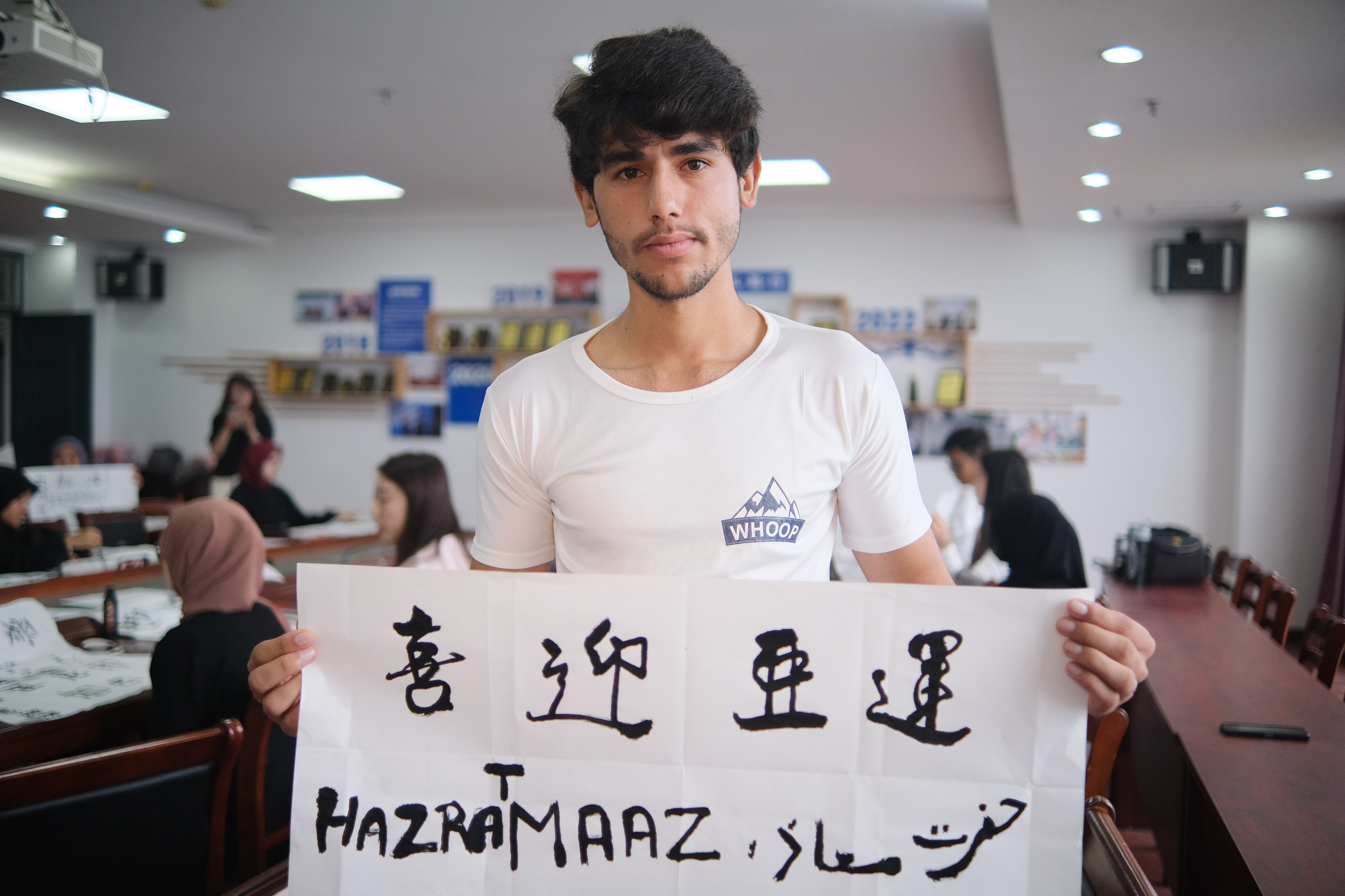 A photo taken on September 13, 2023 shows an international student displaying his calligraphy work as part of an Asian Games well-wishing activity held in Nantong, Jiangsu. /IC