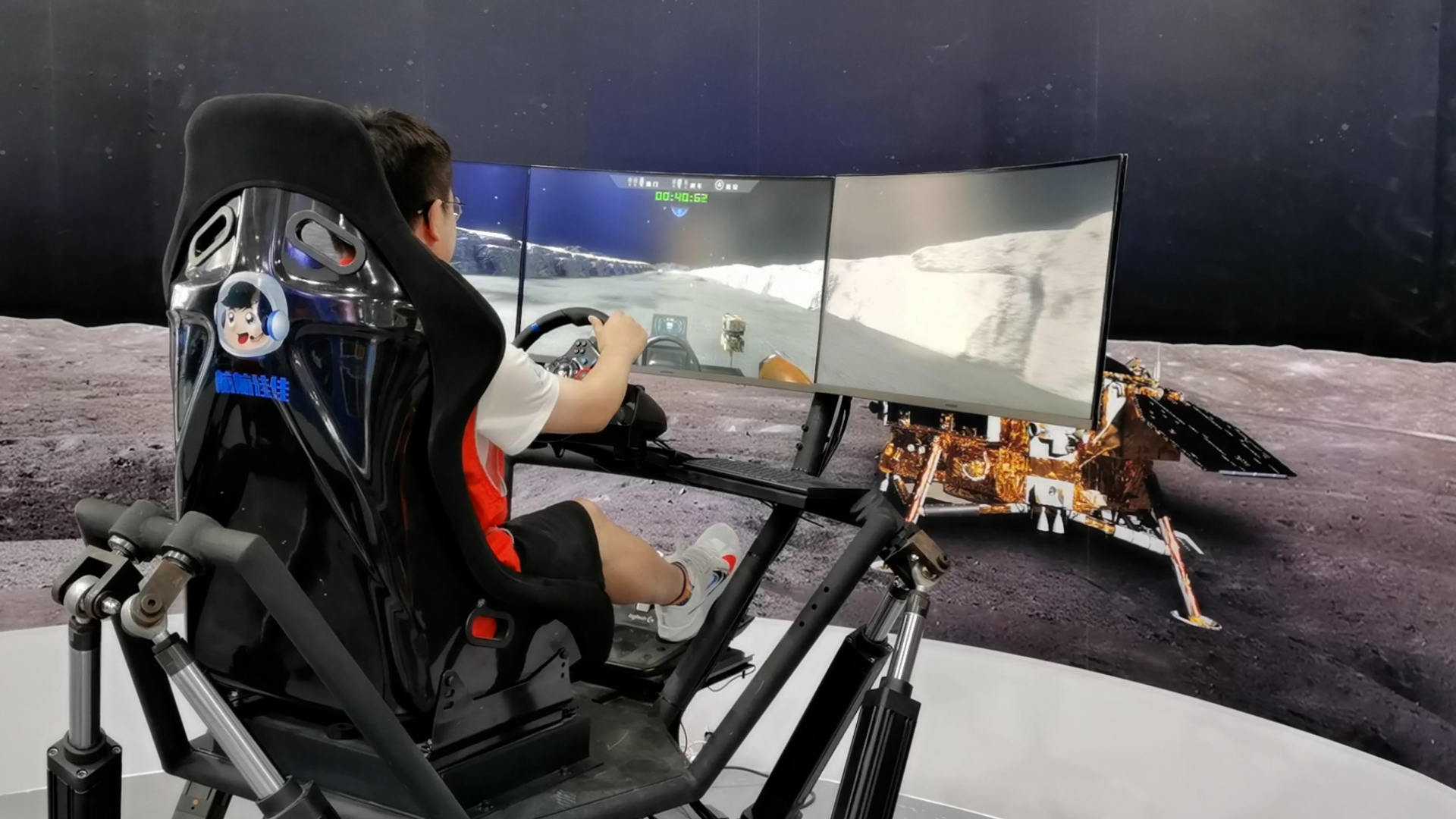 A visitor drives a lunar vehicle in a simulator, Beijing, China, September 15, 2023. /CGTN