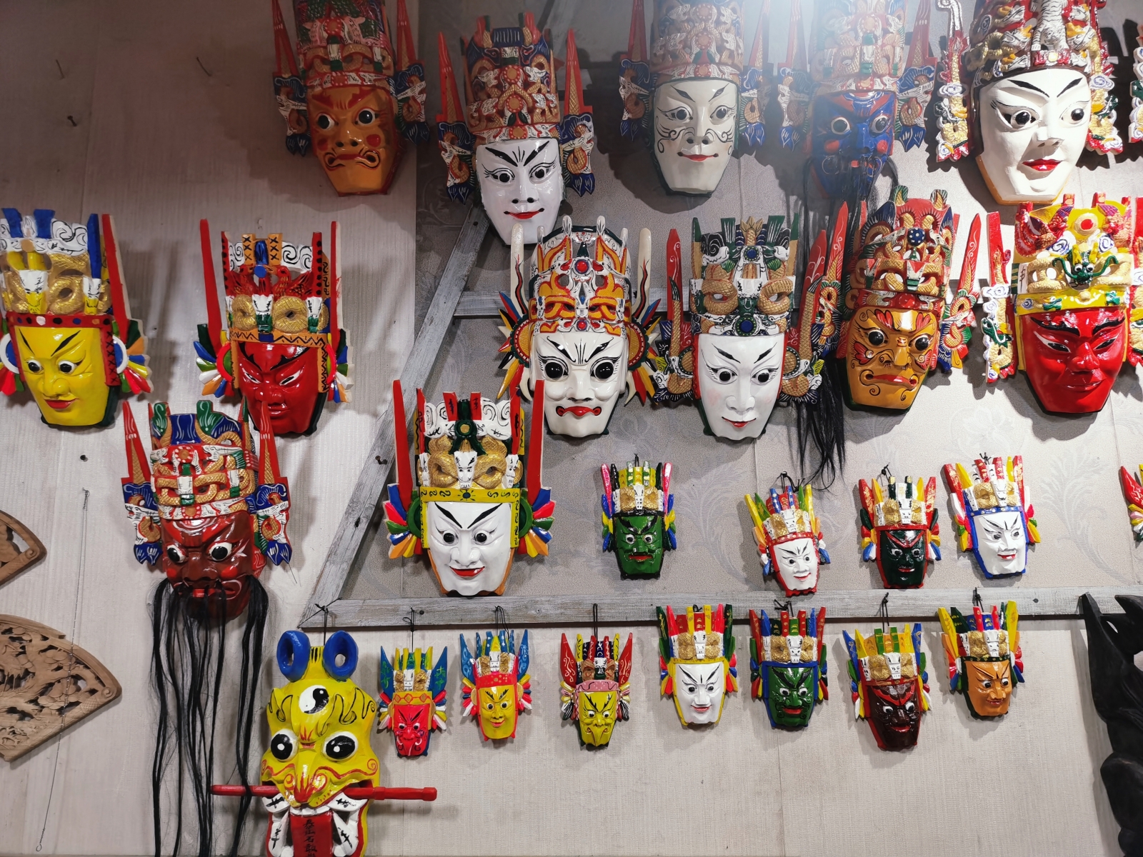 Wooden masks used in dixi opera, or ground opera, are on sale at a shop in Tianlong Tunpu town in Anshun, southwest China's Guizhou Province on August 27, 2023. /CGTN