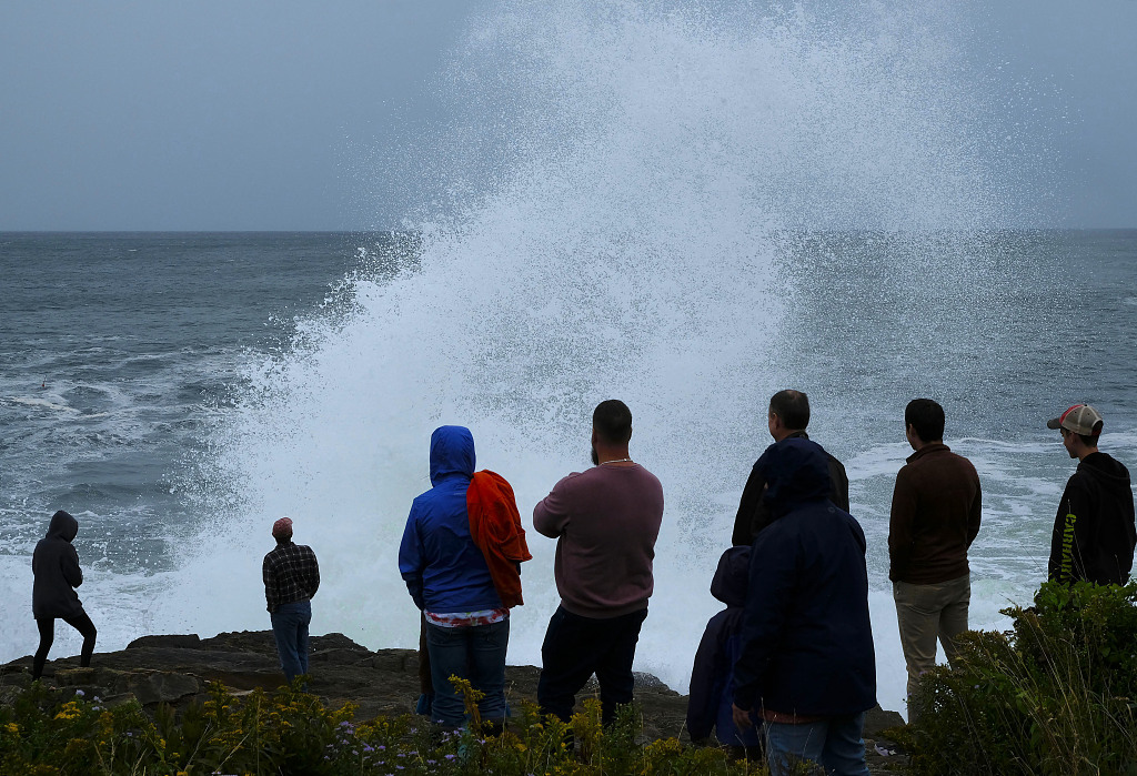 People watch rough surf and waves, remnants of Hurricane Lee, crash along the shore of Bailey Island, Maine, U.S., September 16, 2023. /CFP