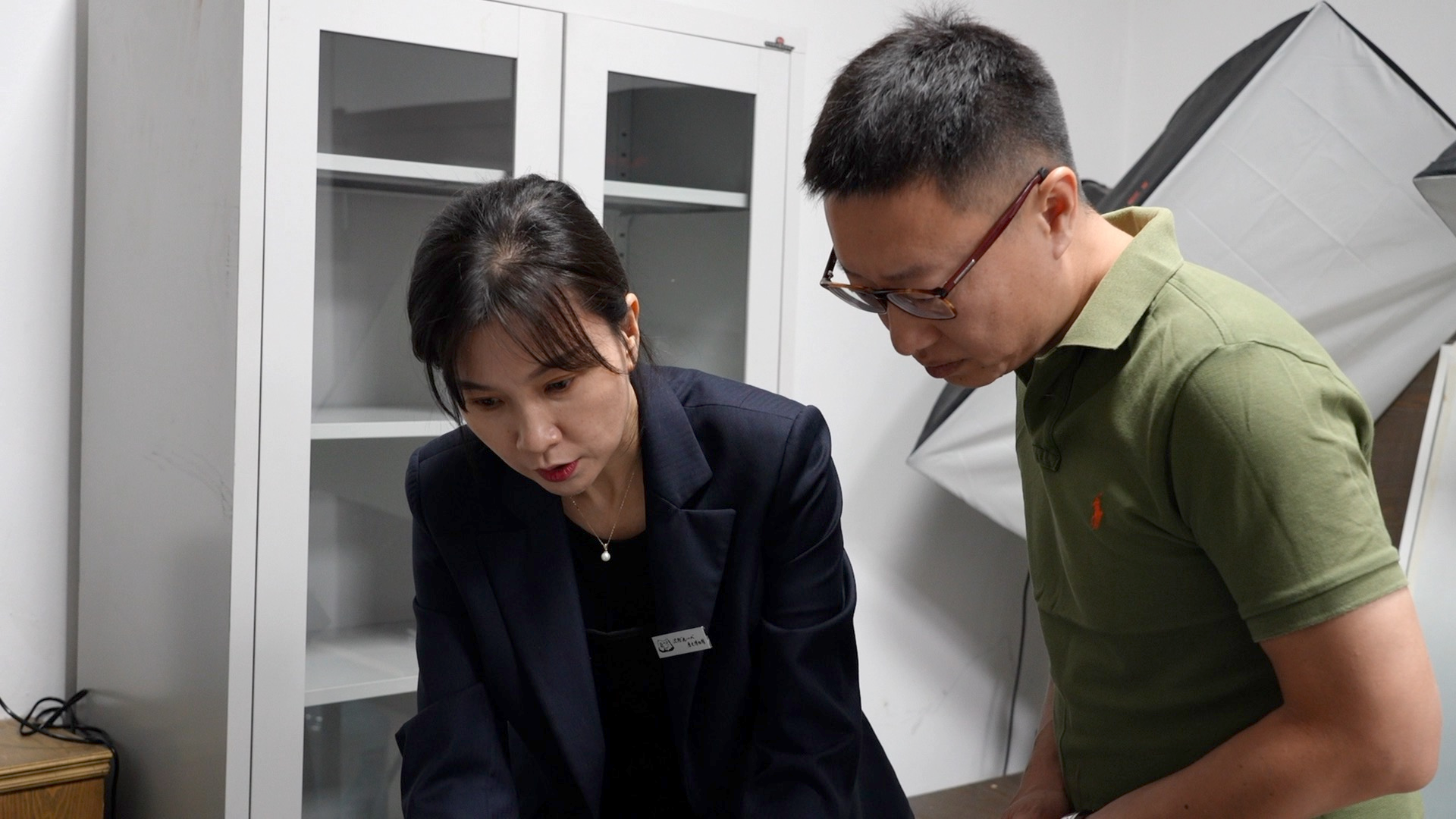Bai Yu, left, the head of the Office of Collection Management at the 9.18 Historical Museum, tells CGTN that war material donations were carried out on a regular basis, with the purpose of expanding knowledge, deepening awareness and providing appreciation to visitors. /CGTN