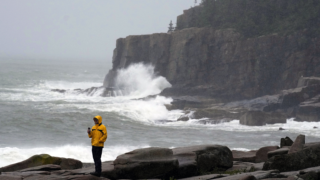 Chris Crawford films the raging surf near Otter Point in Acadia National Park as severe weather associated with storm Lee pounds the region, September 16, 2023, Bar Harbor, Maine. /CFP