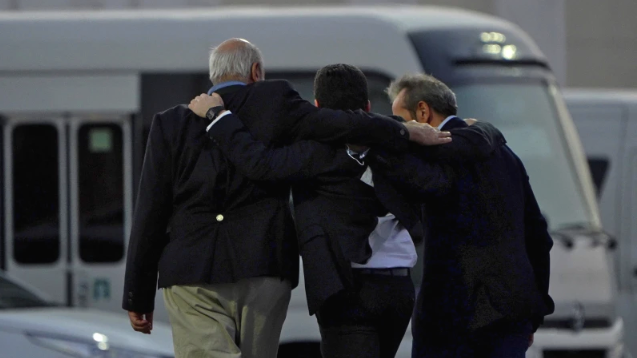 From left, Morad Tahbaz, Siamak Namazi, and Emad Sharghi walk away arm in arm from a Qatar Airways flight that brought them out of Tehran and to Doha, Qatar, September 18, 2023. /AP